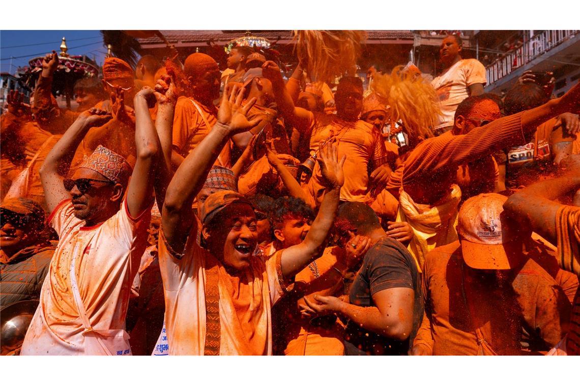 Bilder des Tages Angehörige der Newari-Gemeinschaft spielen in Bhaktapur in Nepal auf traditionellen Instrumenten, während sie sich während des Sindoor Jatra-Festivals gegenseitig mit Zinnoberpulver (Sindoor) bewerfen.
