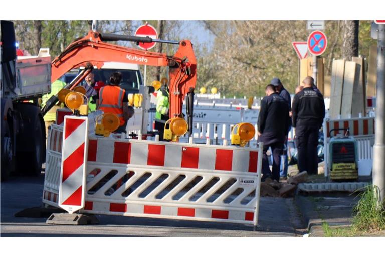 Bauarbeiter und Mitarbeiter vom Kampfmittelbeseitigungsdienst stehen an der Baugrube, in der die Bombe gefunden wurde.