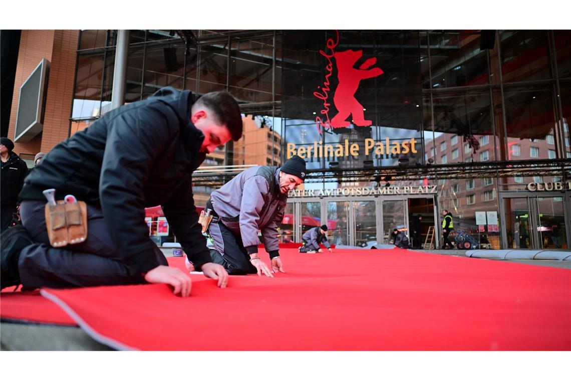 Bilder des Tages Berlinale 2025 - Arbeiter verlegen den roten Teppich vor dem Berlinale Palast.