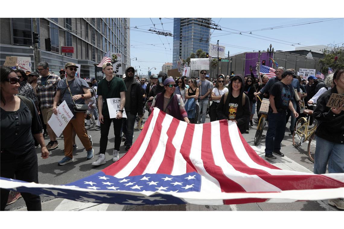 "No Kings": Landesweite Proteste gegen Trump Demonstranten in San Francisco marschierten mit einer großen US-Flagge.