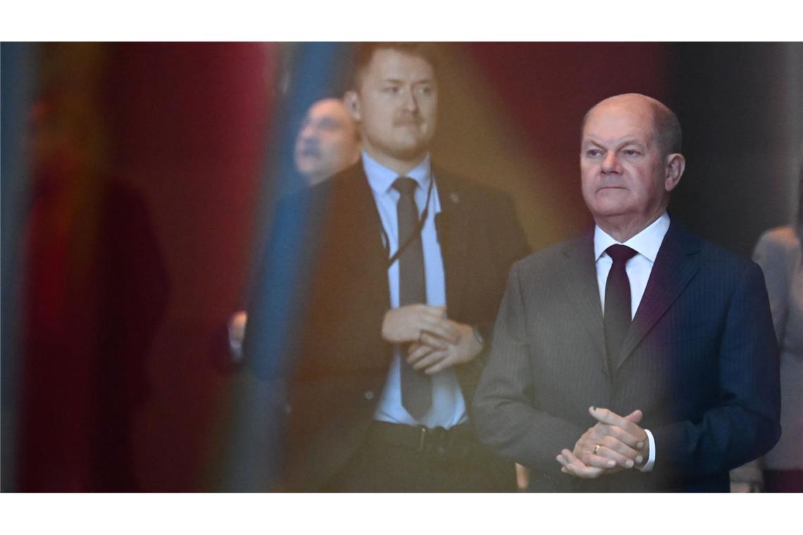 Bilder des Tages Der Alltag geht auch in der Regierungskrise weiter: Bundeskanzler Olaf Scholz steht vor der Begrüßung des kirgisischen Präsidenten im Bundeskanzleramt hinter einer Scheibe.