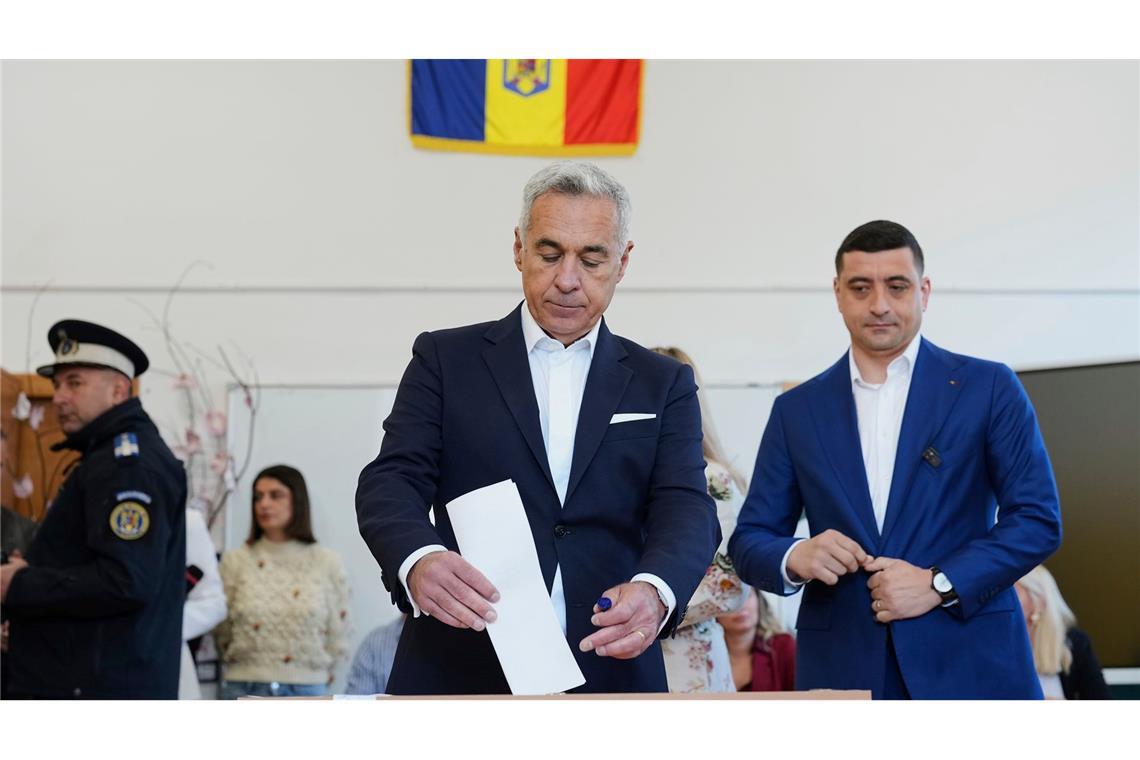 Proeuropäer Nicusor Dan gewinnt Präsidentenwahl in Rumänien Der Kremlfreund Calin Georgescu, Gewinner der ersten Runde der annullierten Wahlen im letzten Jahr, gibt seine Stimme neben seinem politischen Schützling dem Präsidentschaftskandidaten George Simion (r) in der zweiten Runde der Wiederholung der Präsidentschaftswahlen ab.