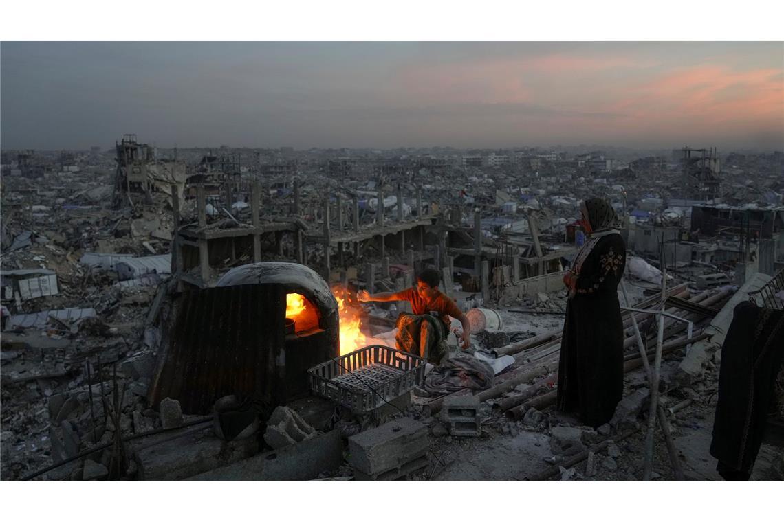 Bilder des Tages Der Palästinenser Ali Marouf und seine Mutter Aisha kochen auf dem Dach ihres durch die Luft- und Bodenoffensive der israelischen Armee zerstörten Hauses in Dschabalija.