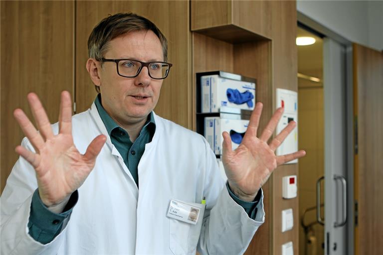 Die Hände müssen sauber sein, erklärt Torsten Ade, Chefarzt der Notaufnahme des Rems-Murr-Klinikums in Winnenden und Hygienefachmann, im Isolierzimmer. Rechts im Hintergrund ist die Tür zum Vorraum zu sehen, in dem die Schutzkleidung angelegt werden muss. Foto: B. Büttner