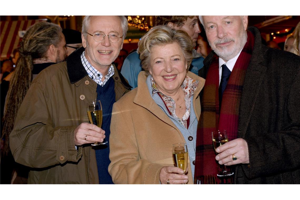 Vor fünf Jahren endete die "Lindenstraße" Die Schauspieler Joachim Hermann Luger (Hans Beimer, links) und die Schauspieler Marie-Luise Marjan (Mutter Beimer) und Bill Mockridge (Erich Schiller, rechts) posieren in der Außenkulisse mit Sektgläsern nach der Live-Ausstrahlung der 1559. Folge im Dezember 2015.