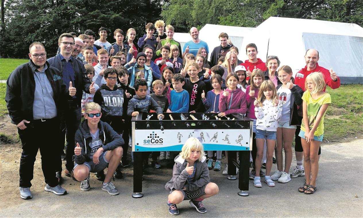Nach dem Frühsport zum Frühstück Die versammelte Mannschaft des Zeltlagers inklusive der Gäste Erich Hägele (Dritter von links) sowie Gernot Gruber (Zweiter von rechts). Als besondere Attraktion gab es für die Kinder einen gespendeten Tischkicker, den sie nun ausgiebig nutzen können. Foto: privat