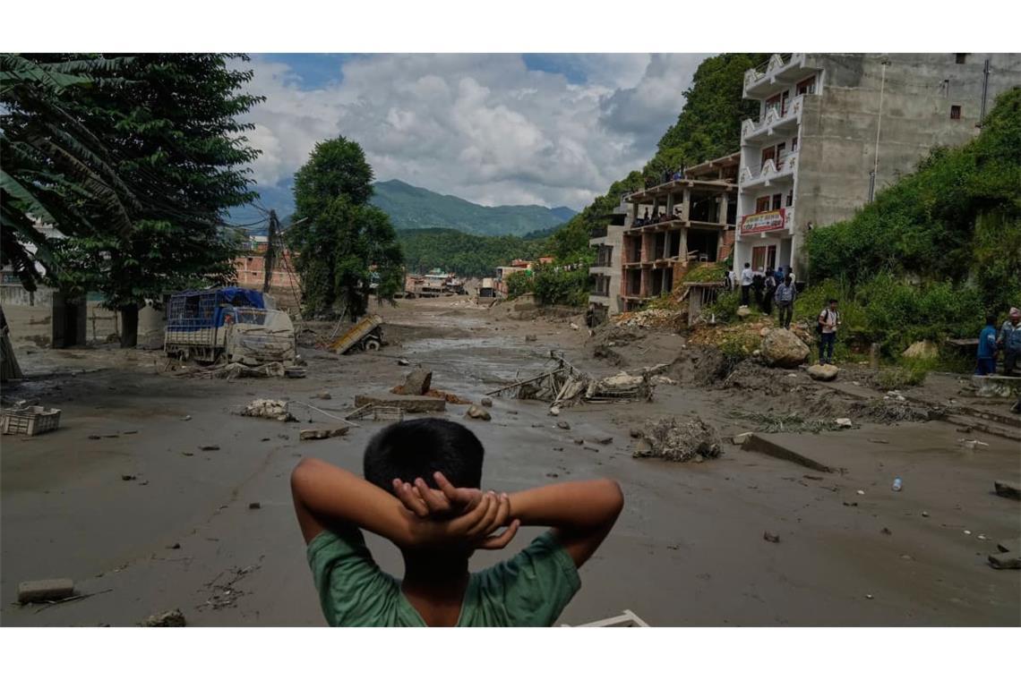 Ein Junge betrachtet die Verwüstungen, die durch Sturzfluten am Fluss Trishuli im nepalesischen Distrikt Nuwakot verursacht wurden. Nach der heftigen Sturzflut in der Grenzregion zwischen China und Nepal gibt es mehrere Tote, nach Behördenangaben werden Hunderte Touristen vermisst.