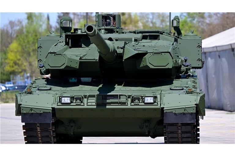 Ein Kampfpanzer Leopard 2 steht auf dem Werksgelände des Unternehmens KNDS vor einer Werkshalle (Archivfoto).