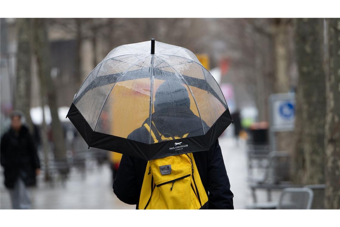 Regen nur Tropfen auf den heißen Stein Ein Mann mit Regenschirm geht durch die Stadt (Symbolfoto).