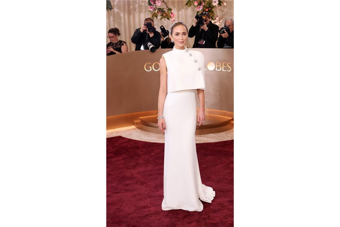 Ein spannendes Ensemble von Louis Vuitton: Emily Blunt trug über einem extrem schlichten weißen Kleid ein asymmetrisches Cape mit Funkelknöpfen.