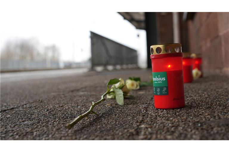 Eine Blume und Kerzen liegen am Bahnsteig nach dem Tod eines Zugbegleiters.