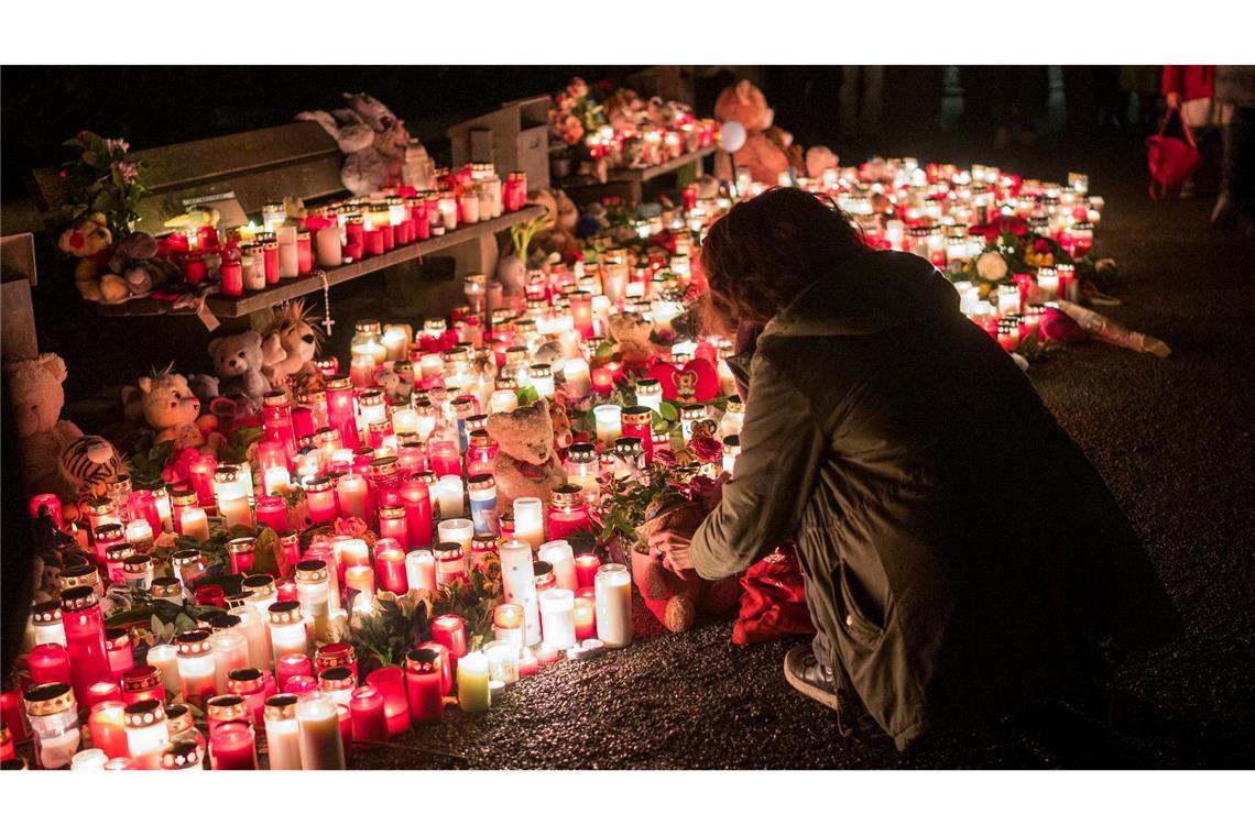 Bilder des Tages Eine Person legt nach der tödlichen Messerattacke im Park Schöntal in Aschaffenburg einen Teddybären bei einer Gedenkstätte nieder.