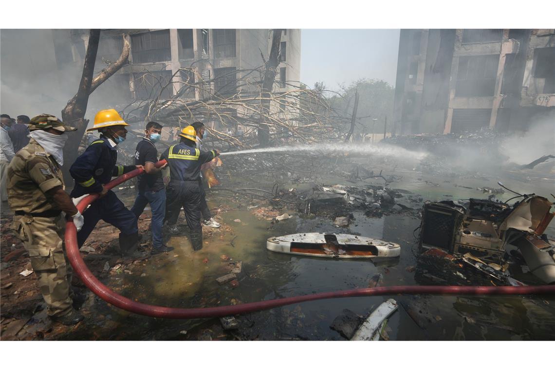 Wie ein Wunder: Passagier überlebt Flugzeugabsturz in Indien Feuerwehrleute sind im Einsatz.