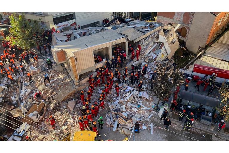 Feuerwehrleute und Rettungskräfte suchen nach dem Einsturz eines Wohngebäudes nach Verschütteten.