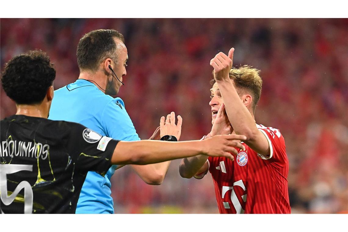 Joshua Kimmich (Bayern München) reklamiert Handspiel bei Schiedsrichter Joao Pinheiro.