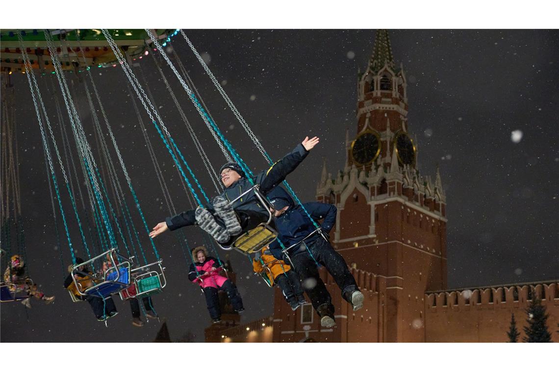 Karussell vor Kremlkulisse: Kinder vergnügen sich auf dem Weihnachtsmarkt am Roten Platz