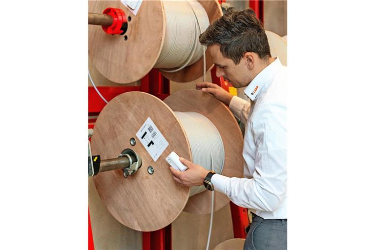 Lapp-Mitarbeiter Dominik Schmalzried mit der intelligenten Kabelrolle, die mit Hilfe eines Sensors den Kabelverbrauch überwacht und gleich nachbestellt.