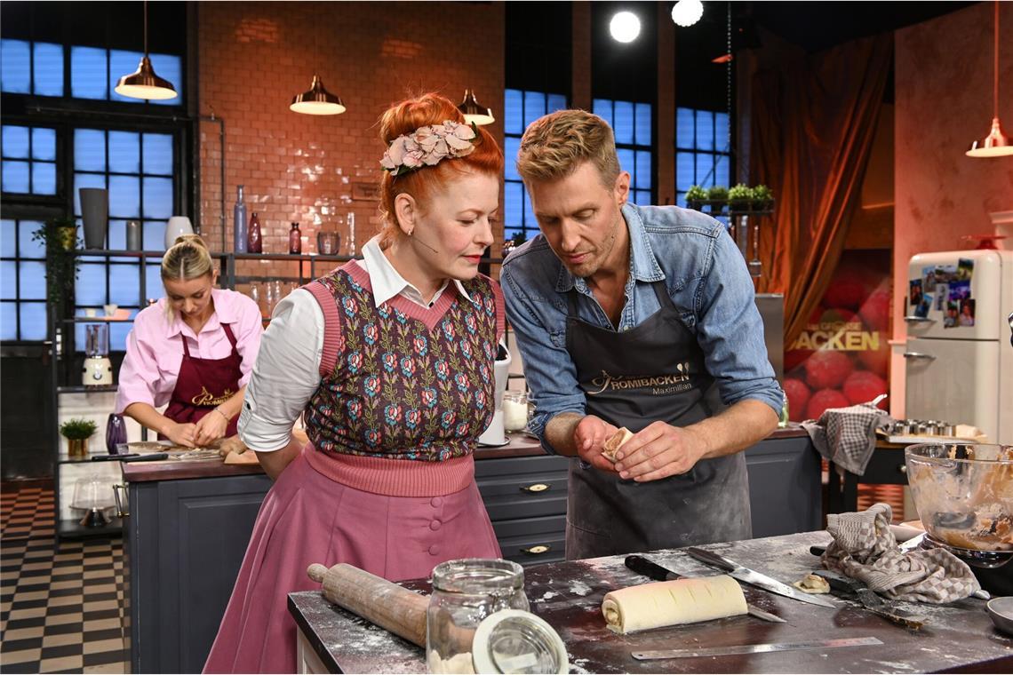 Moderatorin Enie van de Meiklokjes schaut Maximilian Arland über die Schulter.