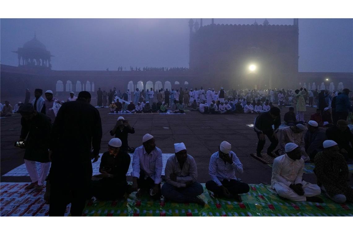 Muslime warten im Morgennebel in der Jama Masjid in Neu Delhi auf das Eid al-Fitr-Gebet am Ende des heiligen Fastenmonats Ramadan.