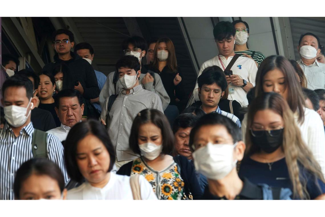 Extrem-Smog in Thailand: Schulen geschlossen Pendler tragen Gesichtsmasken, um sich vor der Luftverschmutzung zu schützen.