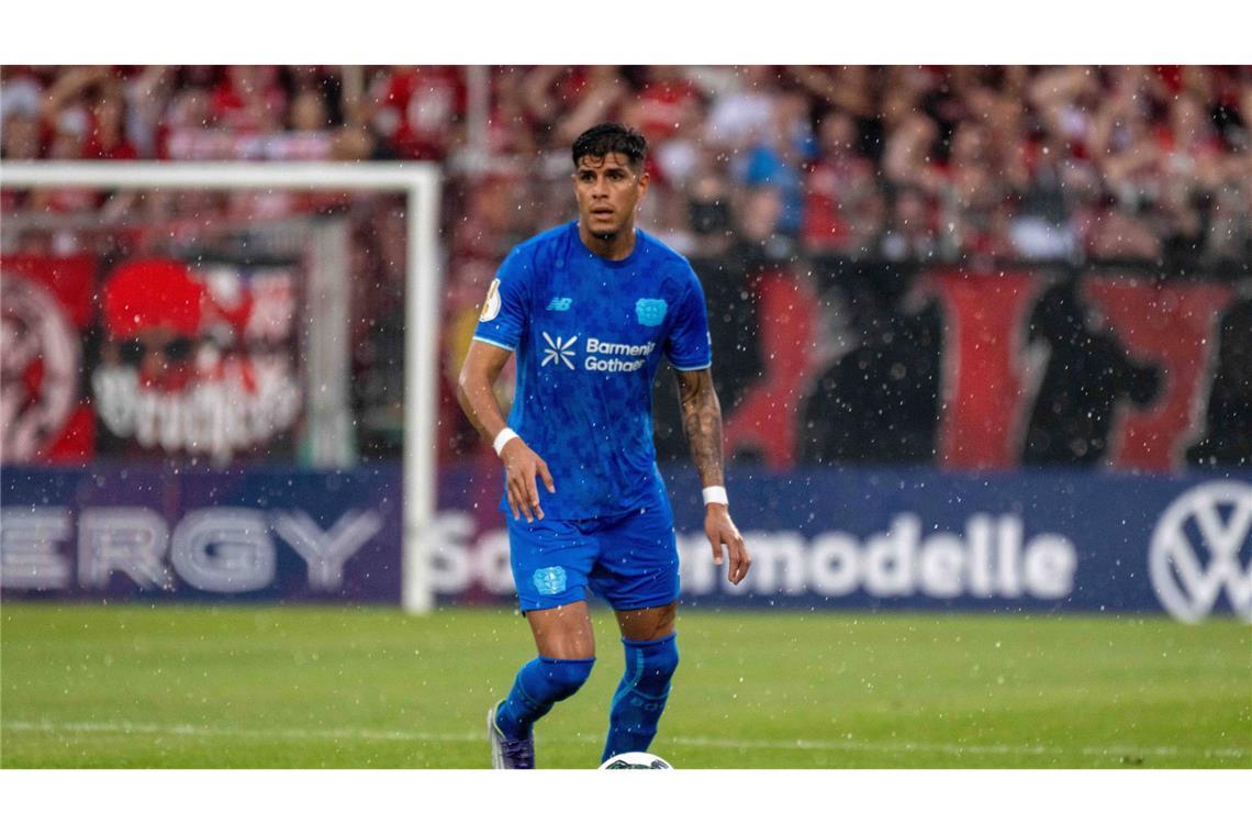 Piero Martin Hincapie Reyna (Bayer 04 Leverkusen) steht auf dem Spielfeld, während es stark regnet.