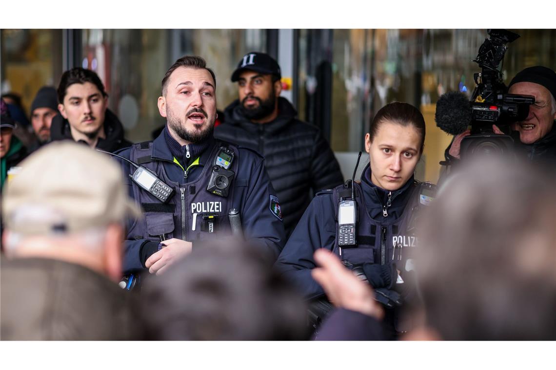 Polizeibeamte sprechen mit möglicherweise betroffenen Kunden der Sparkassenfiliale in Buer.