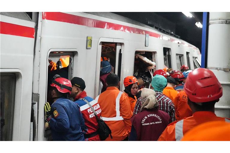Rettungskräfte suchen nach der Zugkollision nach Opfern.