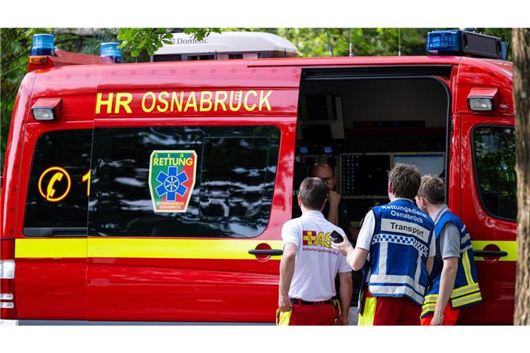 Sanitäter vom Arbeiter-Samariter-Bund stehen an einem Einsatzleitwagen der Feuerwehr am Evakuierungszentrum.