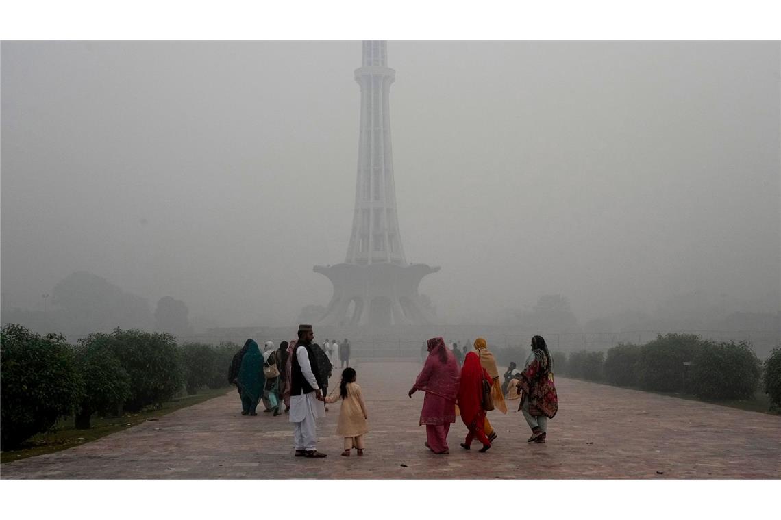Bilder des Tages Schlechte Luft: Familien gehen vor dem Pakistan-Denkmal in Lahore in Pakistan entlang, während Smog die Stadt in eine graue Dunstglocke einhüllt.