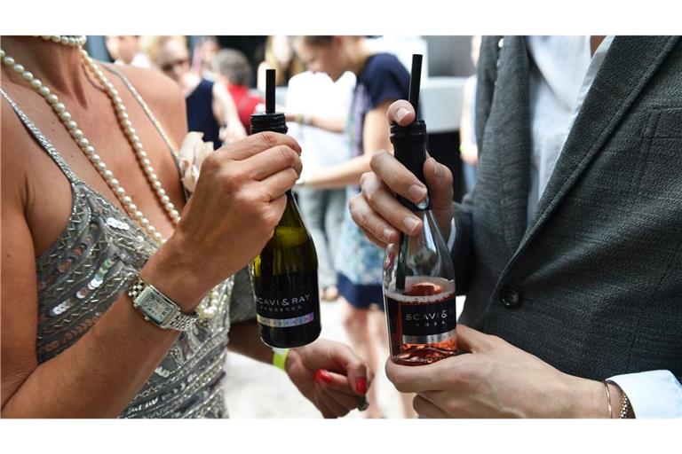 Small Talk mit Prosecco: Gäste unterhalten sich am Rande einer Modenschau in Berlin. (Archivbild)