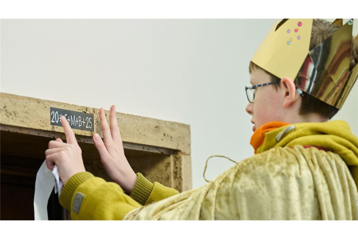 Bilder des Tages Sternsinger im im Roten Rathaus : „20*C+M+B+25“ ist der Schriftzug, den ein Sternsinger am 6. Januar 2025 an eine Tür im im Roten Rathaus klebt.