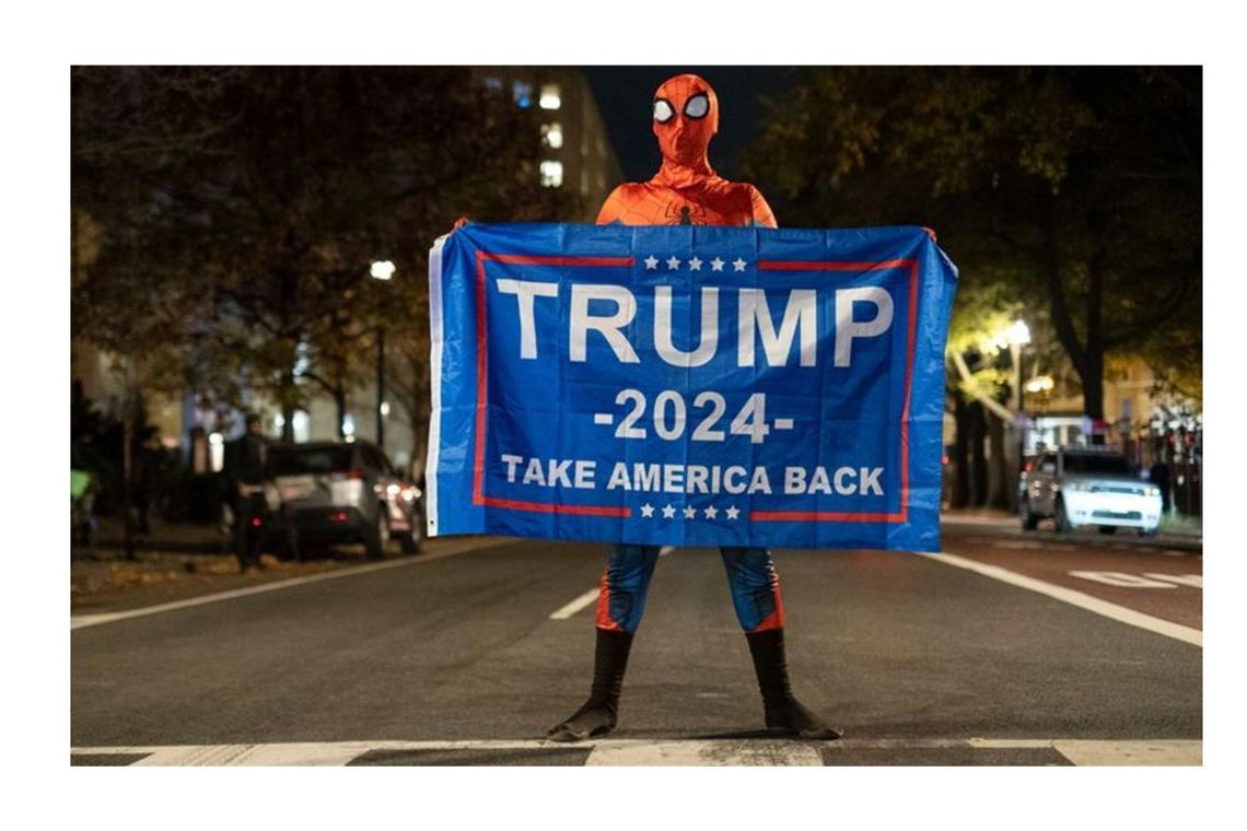 Würden Spider Man und Harry Potter Trump wählen? Trump-Unterstützer im Spider-Man-Kostüm mit einem Trump-Transparent am Tag der US-Präsidentschaftswahl 2024 in Washington.