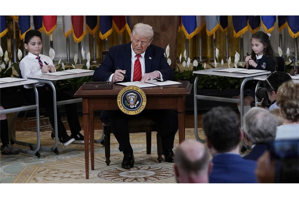 Trump geht Zerschlagung von Bildungsministerium an US-Präsident Donald Trump unterzeichnet bei einer Bildungsveranstaltung eine Durchführungsverordnung im East Room des Weißen Hauses.